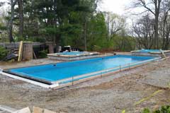 Backfill with dense grade and fill the pool with water