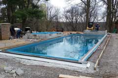Pour concrete patio and construct any features photo 1