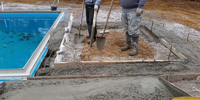 Pour concrete patio and construct any features